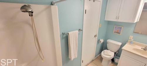 a small bathroom with a toilet and a sink at Aquarius 408 in South Padre Island