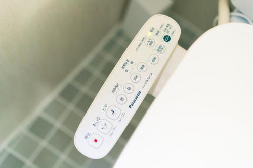 a wii remote control sitting in a room at Yokohama NOIE 横浜ノイエ in Yokohama