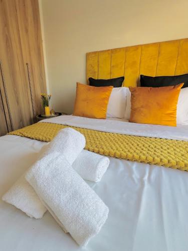 a bed with two white towels on top of it at Lagoon - The Blyde in Pretoria