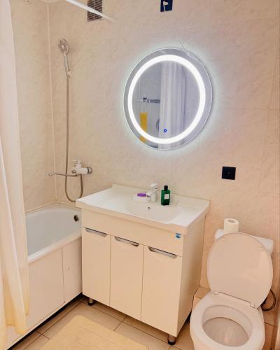 a bathroom with a toilet and a sink and a mirror at Толебаева Центр Талдыкорган in Taldykorgan