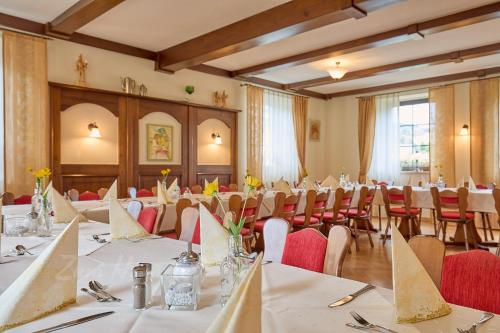 a large room with tables and chairs in it at Landhotel Zum Hammer in Tannenberg