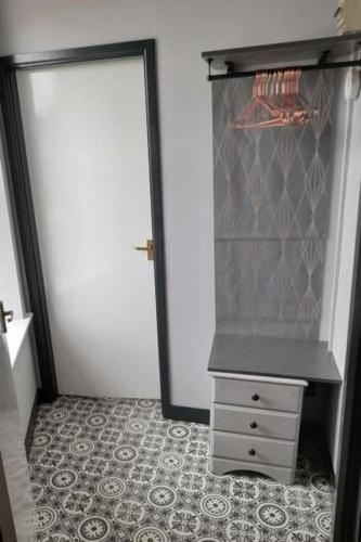 a closet with a door and a dresser in a room at Studio No4, Cockermouth The Lakes in Cockermouth