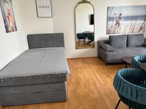 a living room with a bed and a couch at FarawayHomes Studios Klosterneuburg in Klosterneuburg