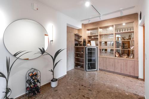 a room with a large mirror and a refrigerator at SISTERS Haus Hotel Garni in Jennersdorf