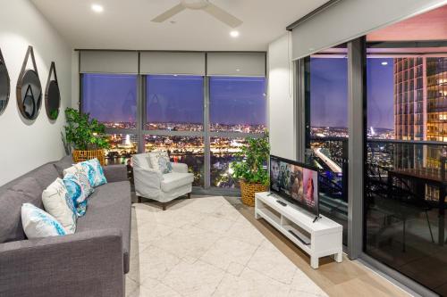 a living room with a couch and a large window at City Beach, Sleeps 6, Inc Carpark, Spectacular River Views, Brisbane CBD Queens Wharf in Brisbane