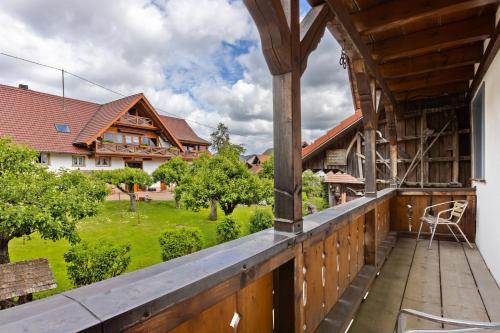 a balcony with a view of a house at Pension Ferienwohnung Baarblick in Donaueschingen