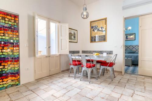 a dining room with a table and chairs at Donna Cesarina - Maison de Charme in Maruggio
