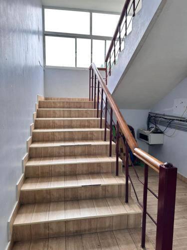 a staircase in a building with wooden steps at SS Grand with swimming pool in Puducherry
