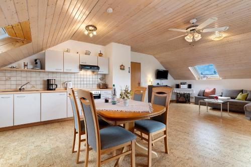 a kitchen and living room with a table and chairs at Ferienwohnung Schillinger in Sasbach am Kaiserstuhl