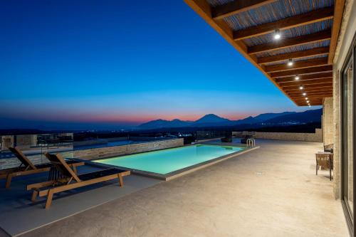 a swimming pool on the roof of a house at Infinity View Luxury Villas in Galiá