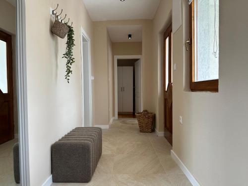 a hallway with a ottoman in the middle of a room at Apartments 16th Street in Mostar