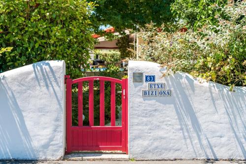 a red gate with a price sign on it at Les Chambres D'arrauntz in Ustaritz