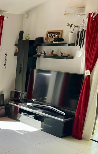 a flat screen tv sitting on top of a table at L'ESCALE COTE BLEUE VILLA & Spa Classée 4 Étoiles in Sausset-les-Pins
