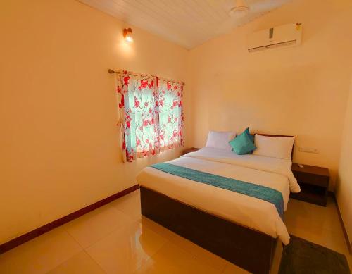 a bedroom with a bed and a window at GreenHouse 5Bhk Villa Alibaug in Alibaug
