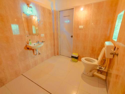 a bathroom with a toilet and a sink at GreenHouse 5Bhk Villa Alibaug in Alibaug