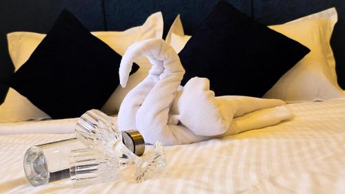 a towel animal laying on top of a bed at Ross Harriet View in Port Blair