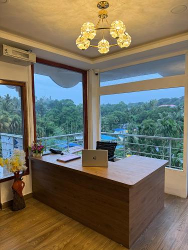 an office with a laptop on a desk with a large window at Ross Harriet View in Port Blair