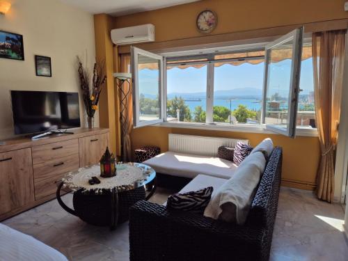 a living room with a couch and a table at MarlenKay in Chalkida