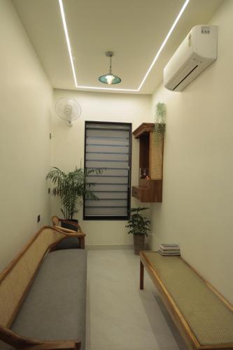 a room with two beds and a window at Narayana Homes in Mathura