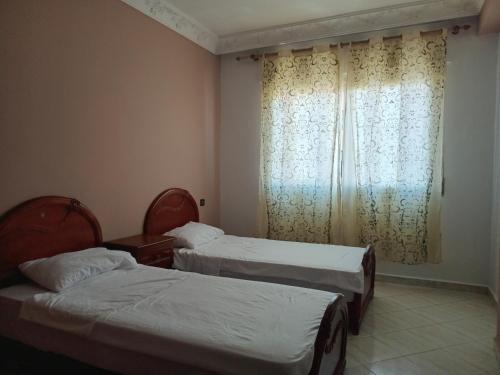 Ένα ή περισσότερα κρεβάτια σε δωμάτιο στο Appartement Tanger centre centro