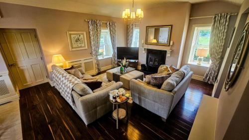 a living room with two couches and a television at Devlin's cottage near Slane in Slane