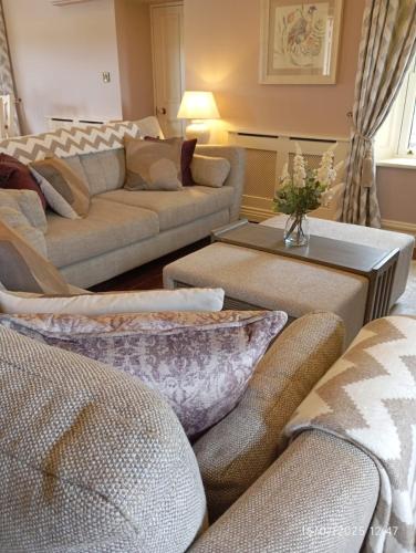 a living room with couches and a table at Devlin's cottage near Slane in Slane