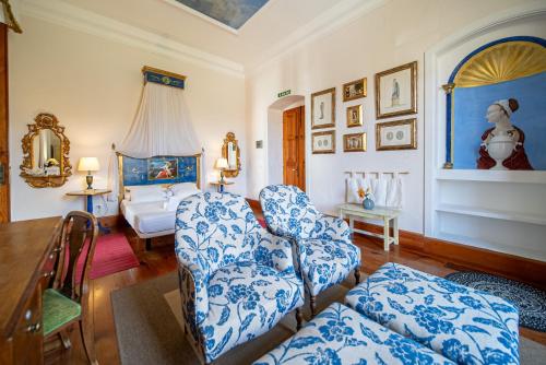 a living room with a couch and a bedroom at La Casona de Yaiza I Hotel Emblematico in Yaiza