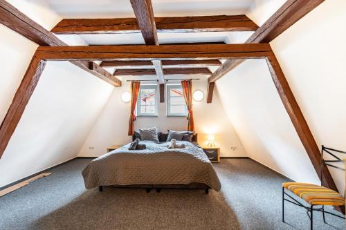 a bedroom with a large bed in a attic at Bacchus Holiday Homes in Bacharach