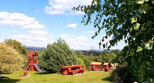 a park with a playground with a slide and a red slideintend at U Srubu Sychrov in Sychrov
