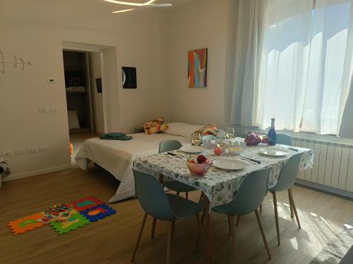 a room with a table with chairs and a bed at A Casa di Raffi by Holiday World in Pisogne