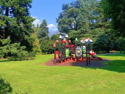a playground in a park with a play equipment at A Casa di Raffi by Holiday World in Pisogne