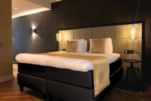Postel nebo postele na pokoji v ubytování Hotel Die Port van Cleve