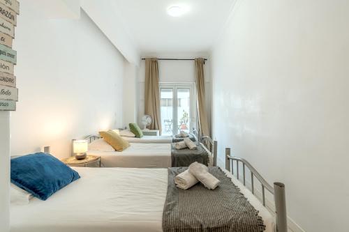 a bedroom with two beds and a window at Estrela House by Homing in Lisbon