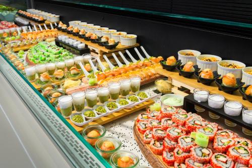 a buffet with many different types of food on display at Avra Beach Resort in Ixia
