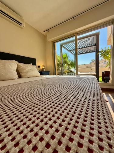 a bedroom with a large bed with a large window at French Riviera - Monaco in Beausoleil
