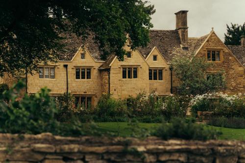 an old stone house with a garden in front of it at Hyll Hotel in Chipping Campden