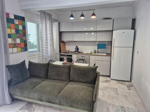 a living room with a couch and a kitchen at Lovely place in Perea in Perea