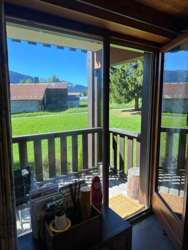 a kitchen with a view of a field through a sliding glass door at standing 4 étoiles in Demi-Quartier