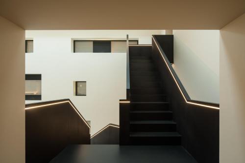 a staircase in a building with a stair case at SFEEL设计师酒店 Designer Hotel成都春熙路IFS国金中心店 in Chengdu