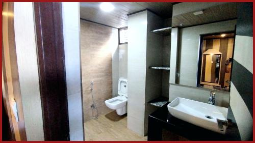 a bathroom with a sink and a toilet at A Top Rated Hotel B-R-O-A-D-A-Y - Mall Road - Luxury & Spacious Room - Book Now in Darjeeling