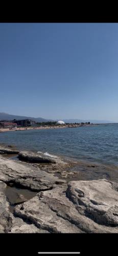 a view of the ocean with rocks and water at Кыргызское ВЗМОРЬЕ in Bosteri