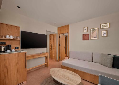 a living room with a couch and a flat screen tv at Paloma Grida in Belek