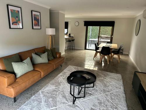 a living room with a couch and a table at Inverloch Palm Waters 5 in Inverloch