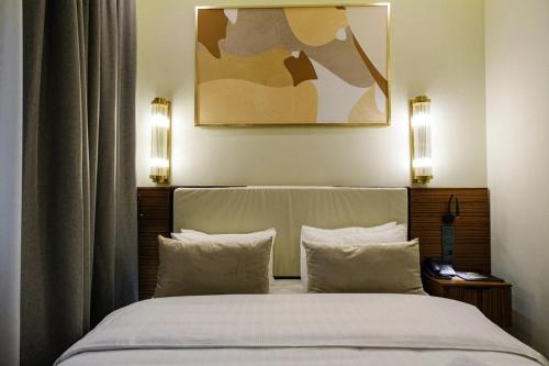 a bedroom with a large bed with two pillows at Kazakhstan Hotel in Almaty