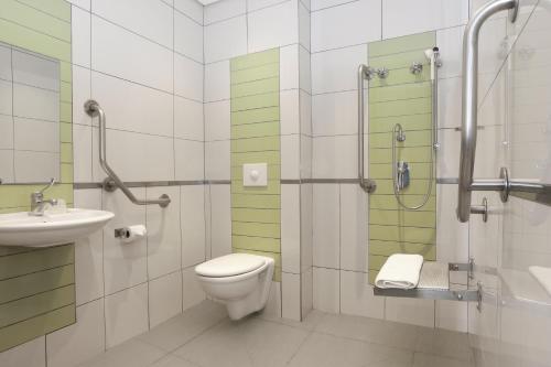 a bathroom with a toilet and a sink and a shower at SUN1 ALBERTON in Johannesburg