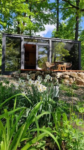 a modern house in the middle of a garden at DOBICUBE magánszálláshely - Pilisszentkereszt-Dobogókő in Dobogoko