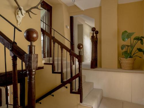 a staircase in a house with a plant at Holwell Farmhouse in Tiverton