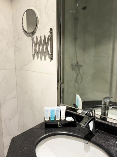 a bathroom counter with a sink and a mirror at Lamar Ajyad First Hotel Tower A in Makkah