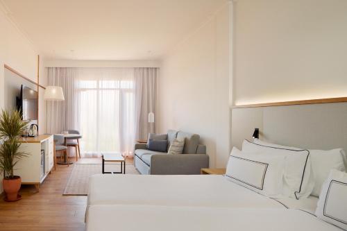a living room with a bed and a couch at Melia Jardines del Teide - Adults Only in Adeje