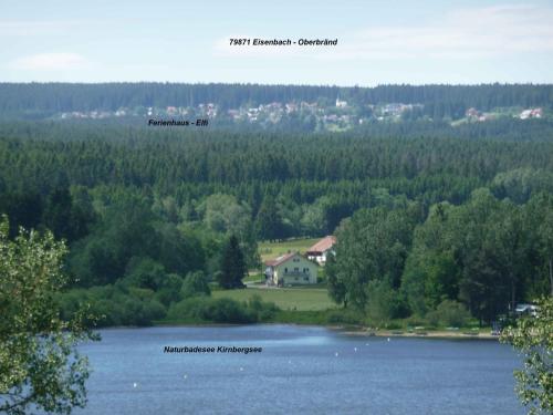 a house on the shore of a lake at Ferienhaus Elfi in Oberbränd